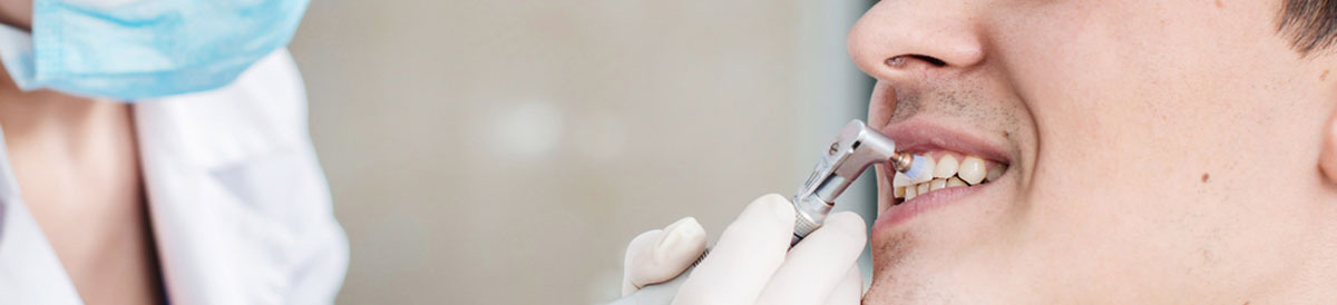 Man having teeth polished by dentist